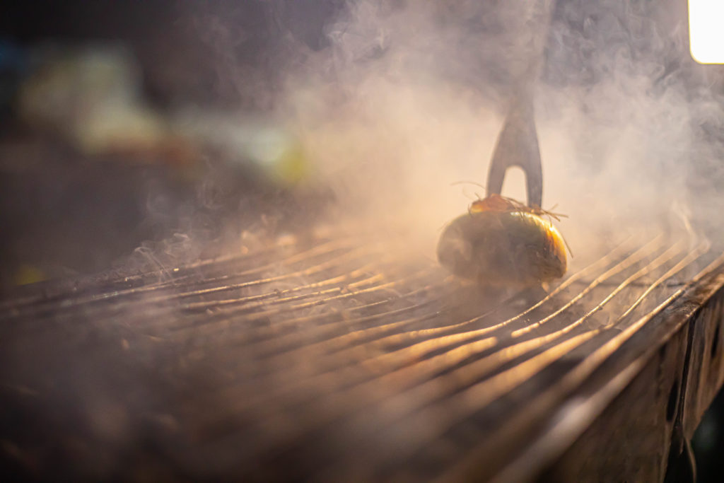 cleaning a grill with an onion