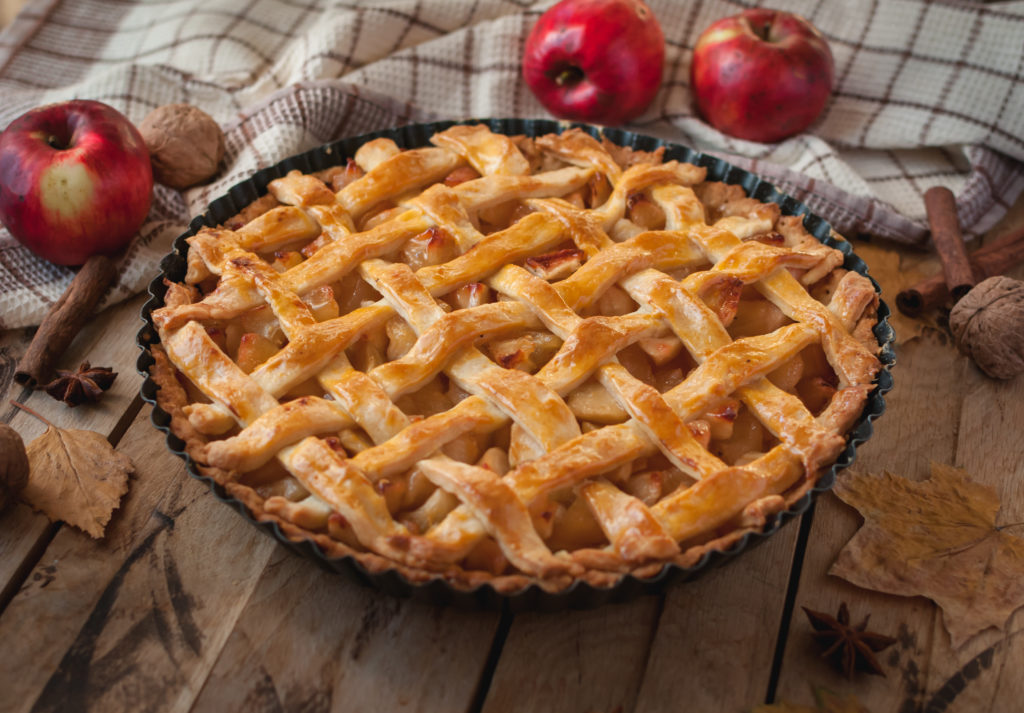 Homemade apple pie on wooden background